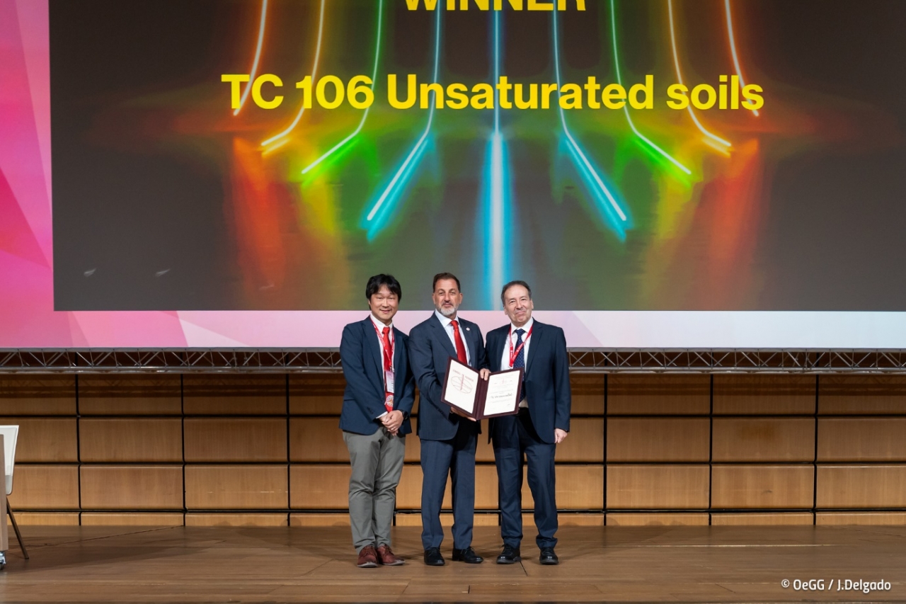 A group of men standing on a stage Description automatically generated