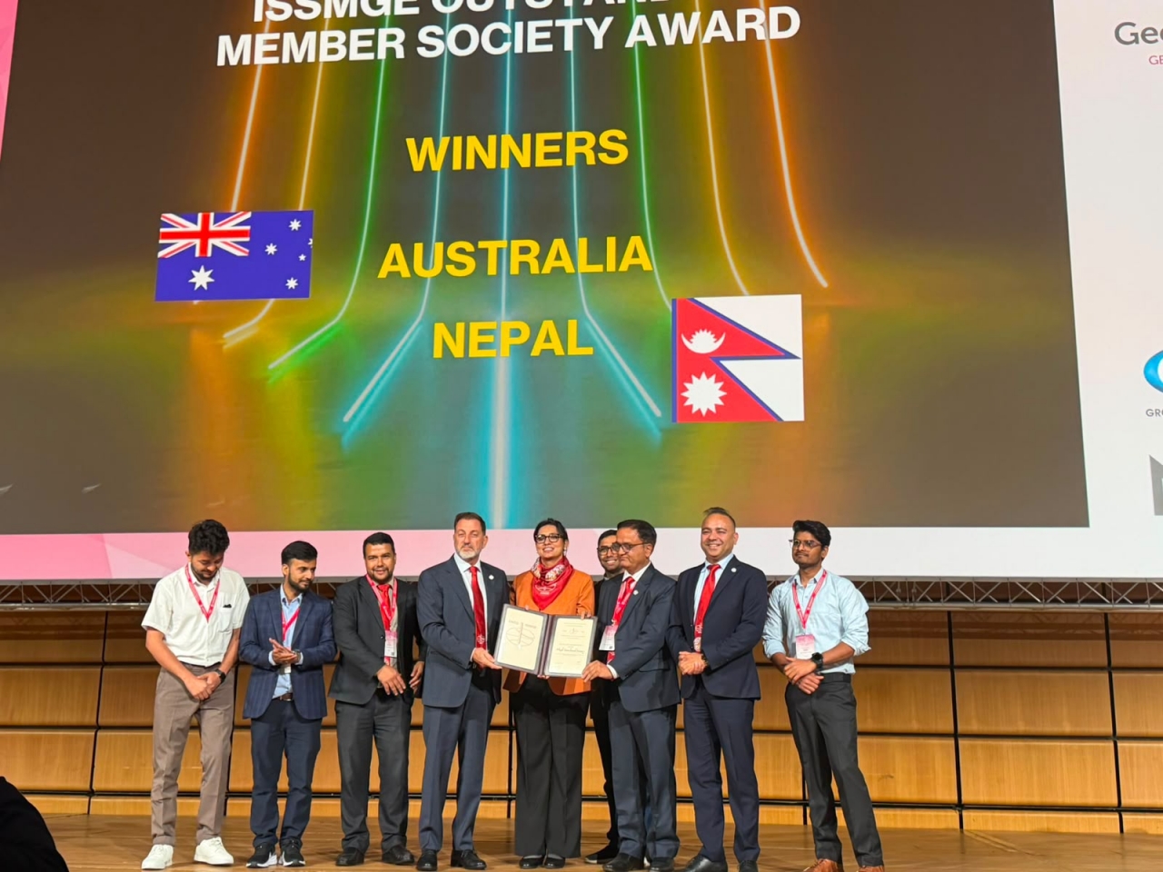 A group of people standing on a stage Description automatically generated